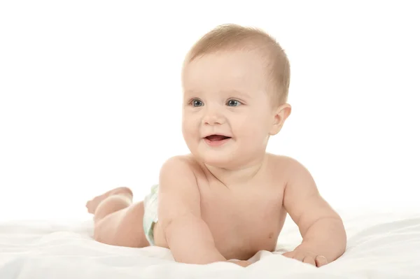 Baby girl  in pampers on blanket — Stockfoto
