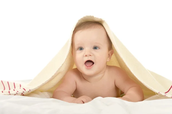 Baby girl lying under blanket — Stock Photo, Image