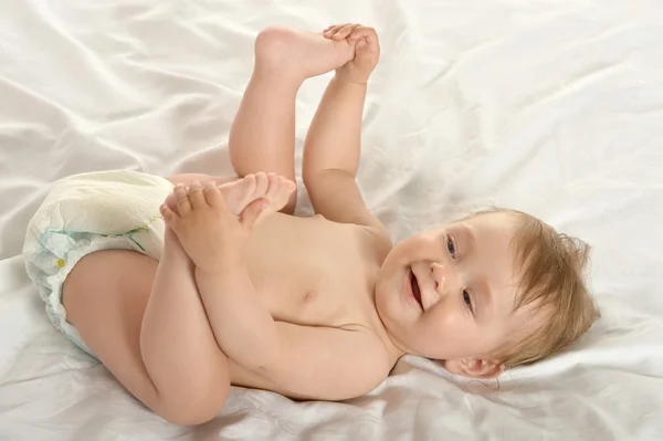 Baby girl lying in pampers — Stock Photo, Image