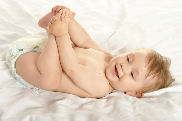 Baby girl lying in pampers — Stok fotoğraf