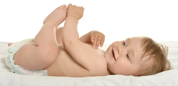 Baby girl lying in pampers — Stock fotografie