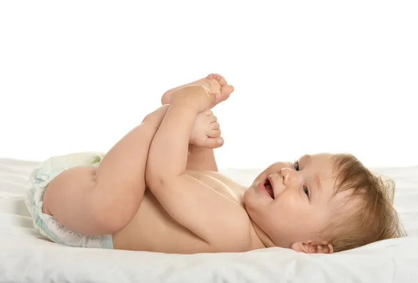 Baby girl lying in pampers — Stockfoto