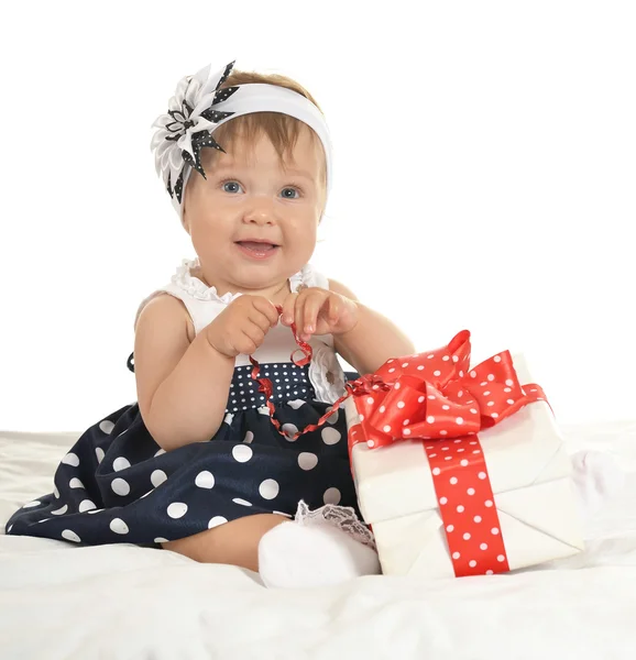 Cute baby girl with gift — Stockfoto