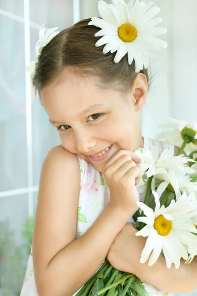 Liten flicka med dasies blommor — Stockfoto