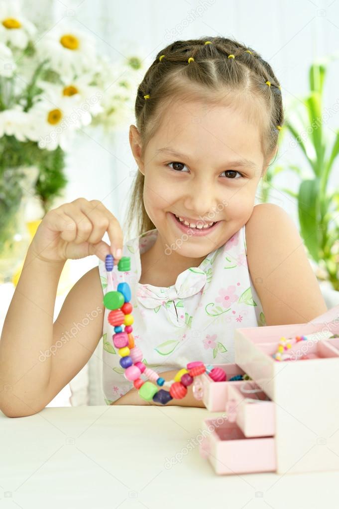 Cute Little girl with beads Stock Photo by ©aletia 78190292