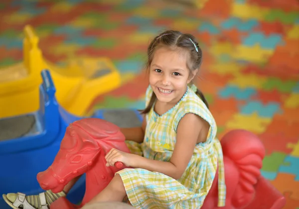 Little girl on  rocking horse. — Stock Photo, Image