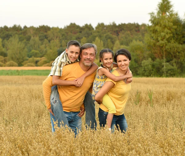 Happy family in wheat field — Stock Photo, Image