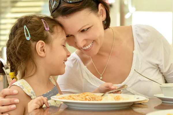 Bambina con madre mangia — Foto Stock