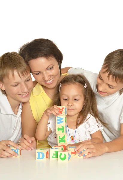 Mother and kids playing with cubes — Stock Photo, Image