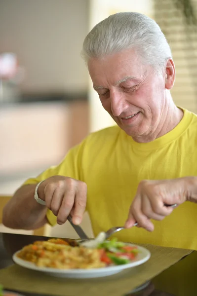 Senior man having breakfast — Stock Photo, Image