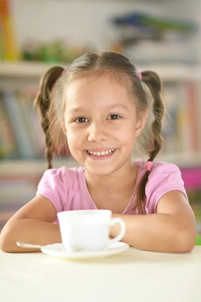 Cute little girl with cup — Stock Photo, Image