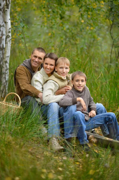 Happy family in autumn forest — Stock Photo, Image