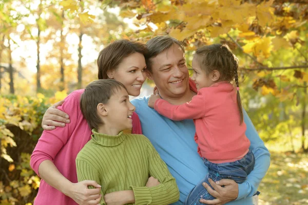 Family relaxing in autumn park — Stock Photo, Image