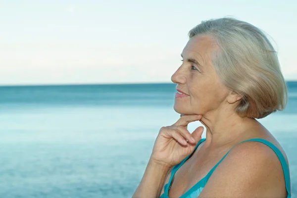 Happy elderly woman on beach — Stock Photo, Image