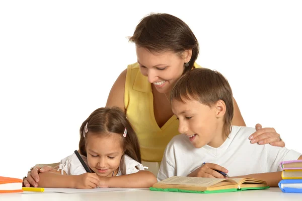 Mother doing homework with her kids — Stock Photo, Image