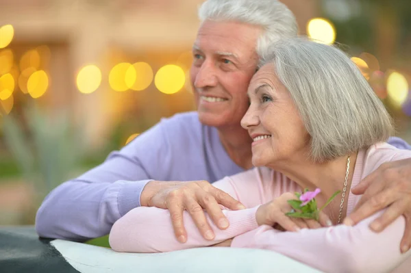 Smiling old couple with flower — Stock Photo, Image