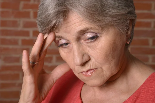 Thoughtful elderly woman — Stock Photo, Image