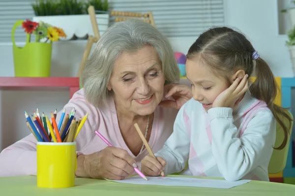Grandmother with granddaughter drawing together — Stock Photo, Image