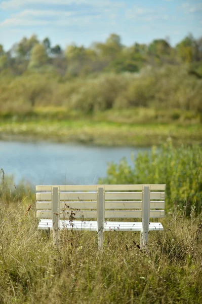 Пустая скамейка у озера — стоковое фото