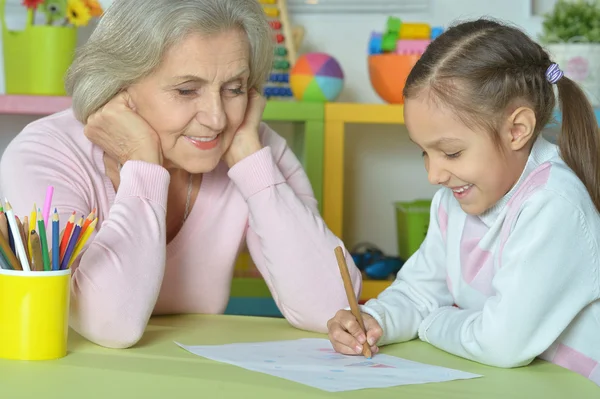 Grandmother with granddaughter drawing together — Stock Photo, Image