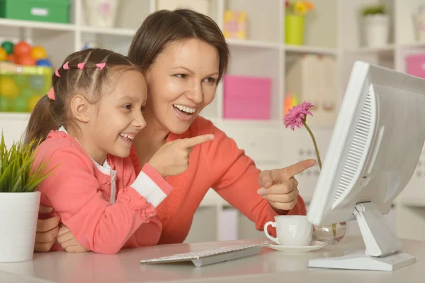 Meisje met moeder doen online winkelen — Stockfoto