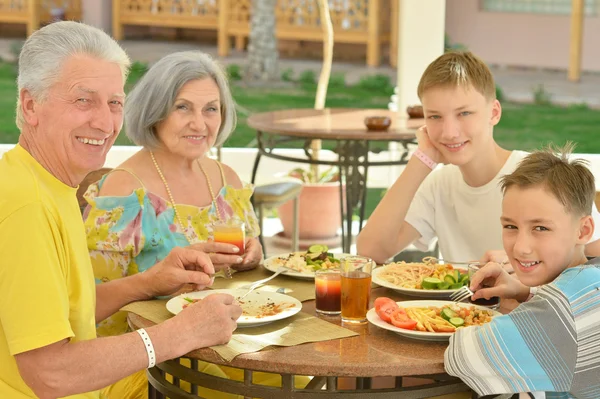 Grandparents with grandchildren at breakfast — Stock Photo, Image