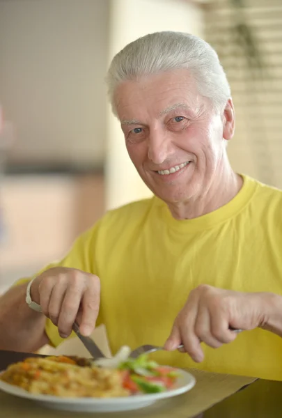 Happy Senior man having breakfast — Stock Photo, Image