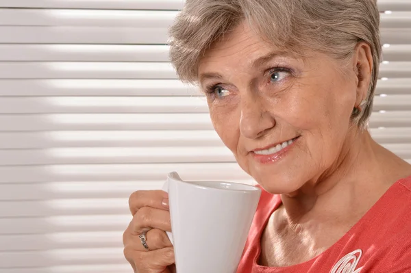 Senior woman with cup — Stock Photo, Image