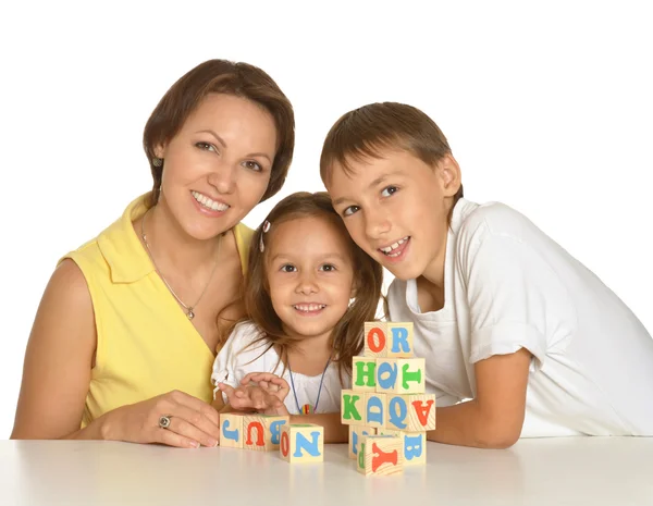 Moeder en kinderen spelen met kubussen — Stockfoto