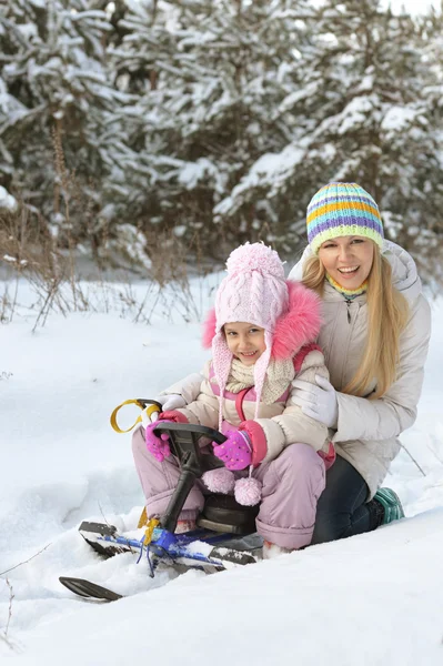 Mother and daughter with  snowmobile — Stock Photo, Image