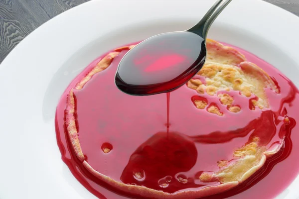 Pancake with cherry syrup — Stock Photo, Image