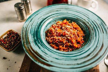 Sebze yahnili tabak ve tahtadan kesme tahtasına susam tohumlu yulaf ezmesi, yakın görüş. 