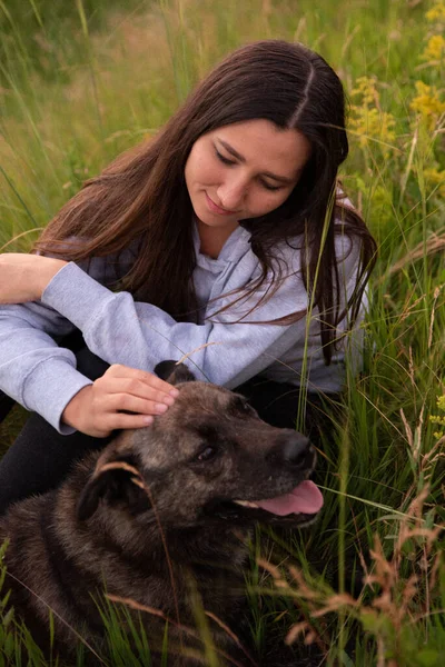 Happy Young Woman With Her Brown Dog Outdoor In The Nature