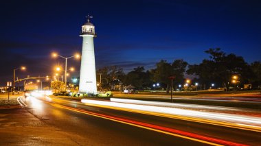 Biloxi Lighthouse at Night and Traffic in The Gulf Coast State o clipart