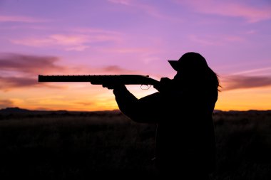 Hunter Silhouetted at Sunset clipart