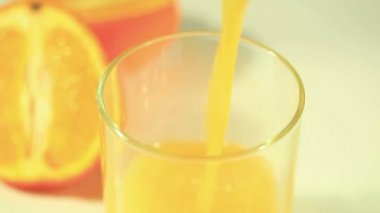 Portakal suyu bir bardak meyve içinde siluetleri ile akar