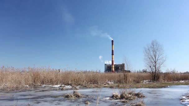 Old plant with  two pipes and a smoke against the blue sky. — Stock Video