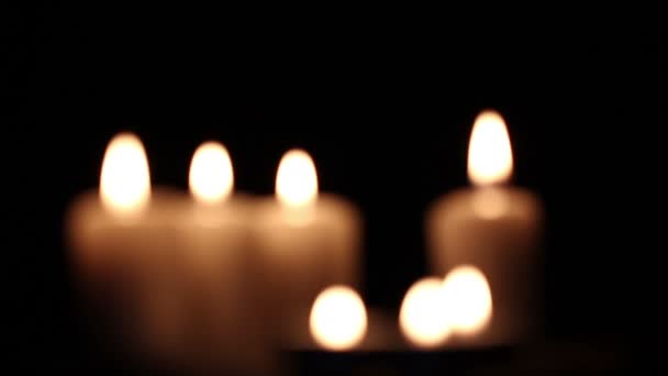 Beautiful burning candles. Blurred scene — Stock Video