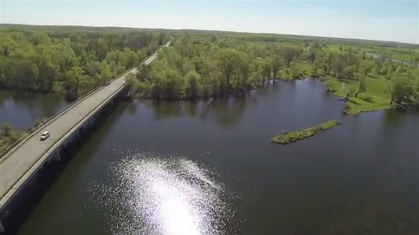 Landskap med vackra floden, Reflektioner av solsken och bridge. Antenn — Stockvideo