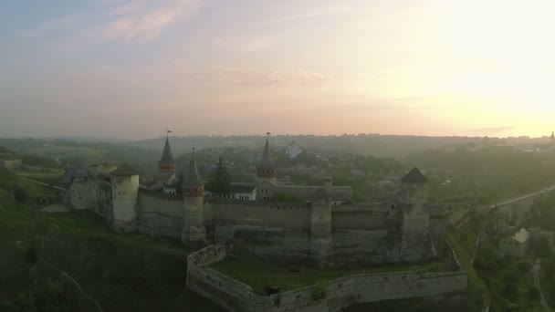 Old fortress in  red beams of  morning sun. Aerial shot — Stock Video