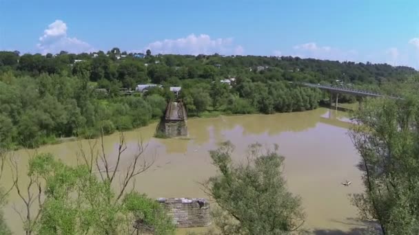 Destroyed bridge through river .Aerial shot — Stock Video