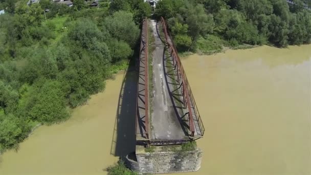 Zniszczonego mostu przez rzekę. Aerial strzał nachylenia kamery — Wideo stockowe