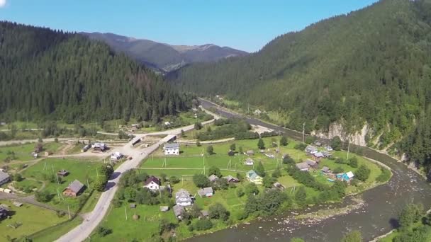 Mountain landscape with turn of  river and village. Aerial shot — Stock Video
