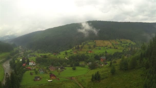 Venkovské horské oblasti s vesnicí v mlhavé den. Antény — Stock video