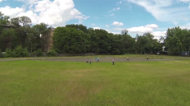 Children play badminton at stadium. Aerial — Stock Video