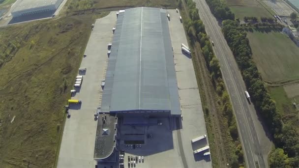 Up over Cargo  warehouse  and highway with cars . Aerial — Stock Video