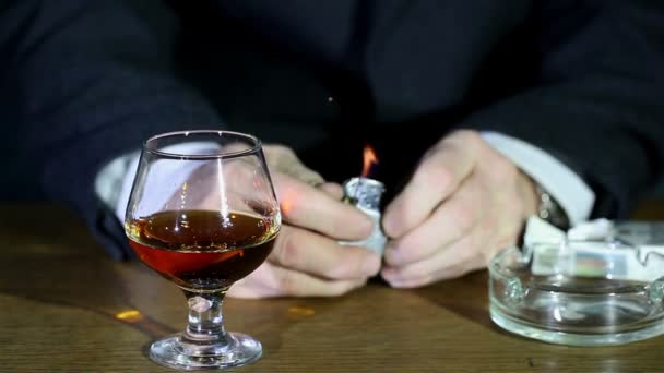 Cognac, lighter and time. Nervous businessman. — Stock Video