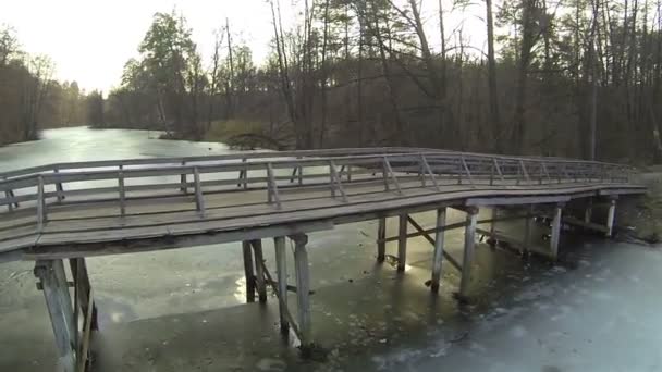 Ξύλινη γέφυρα του ποταμού παγωμένο χειμώνα. Εναέρια — Αρχείο Βίντεο