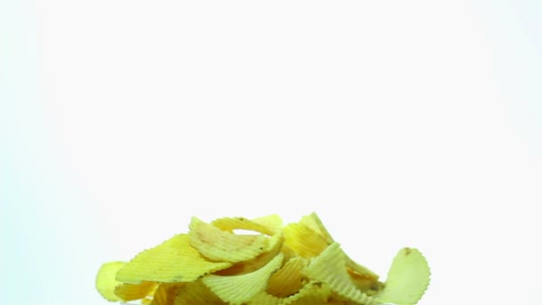 Appetitliche wellige gelbe Chips rotieren auf weißem Hintergrund — Stockvideo