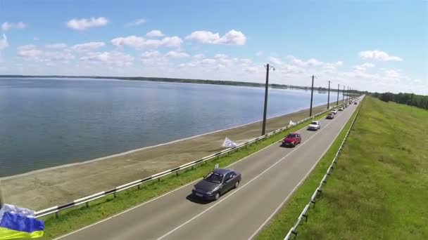 Hermosa carretera con coches y lago. Disparo aéreo — Vídeo de stock